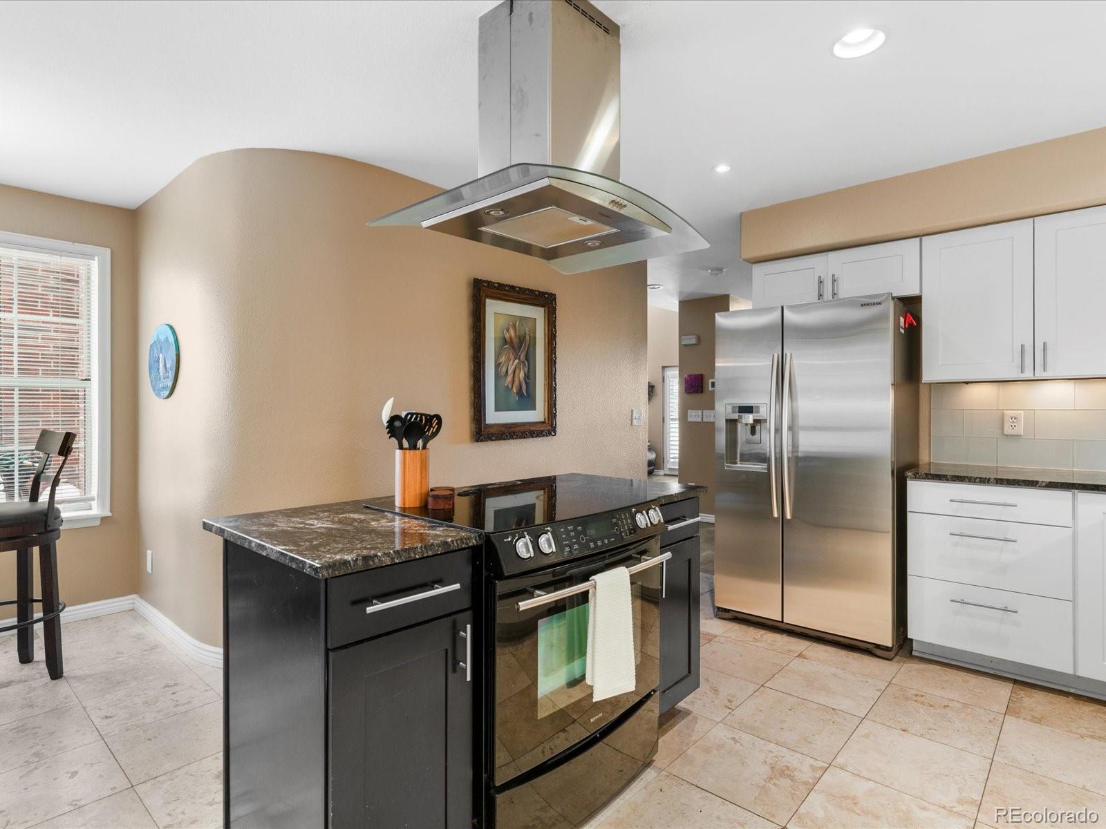 9323 Notts Court Lone Tree, CO 80124 - Photo 17 of 45 a kitchen with stainless steel appliances granite countertop a stove a refrigerator and a sink