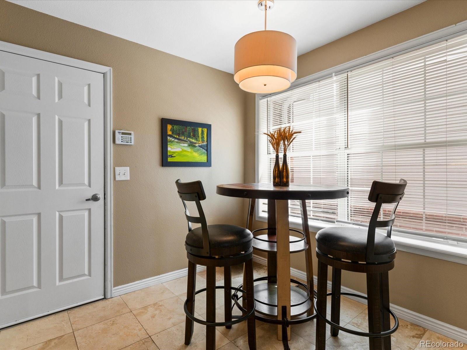 9323 Notts Court Lone Tree, CO 80124 - Photo 19 of 45 a view of a dining room with furniture window and outside view