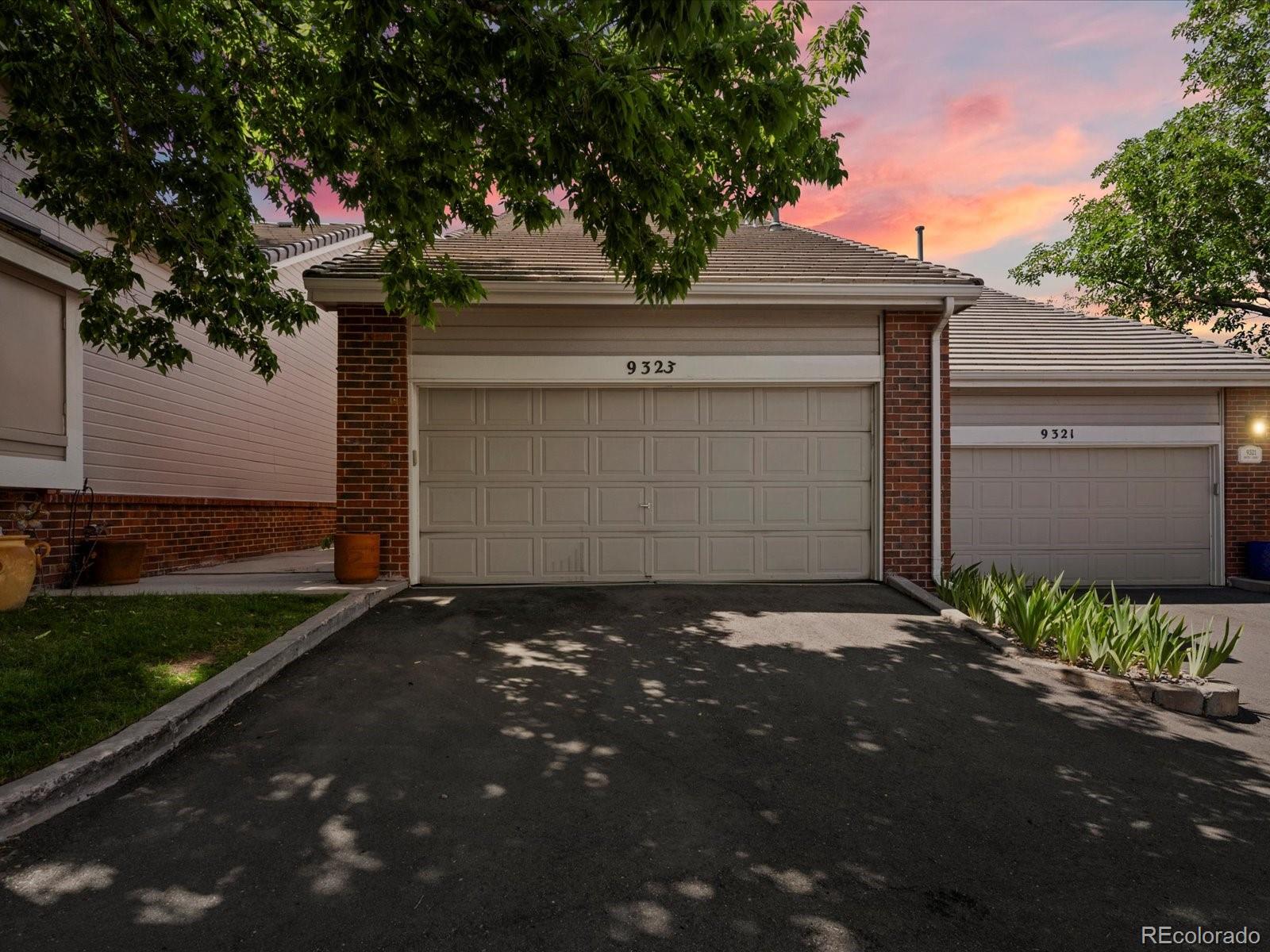9323 Notts Court Lone Tree, CO 80124 - Photo 2 of 45 a front view of a house with a yard and garage