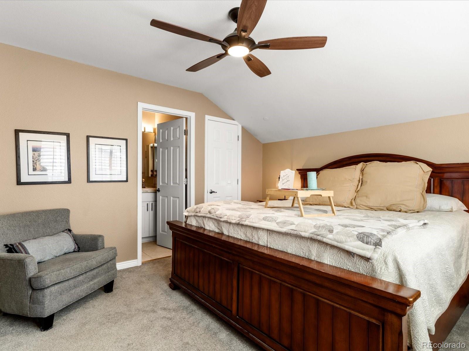 9323 Notts Court Lone Tree, CO 80124 - Photo 30 of 45 a bedroom with a bed and a chandelier