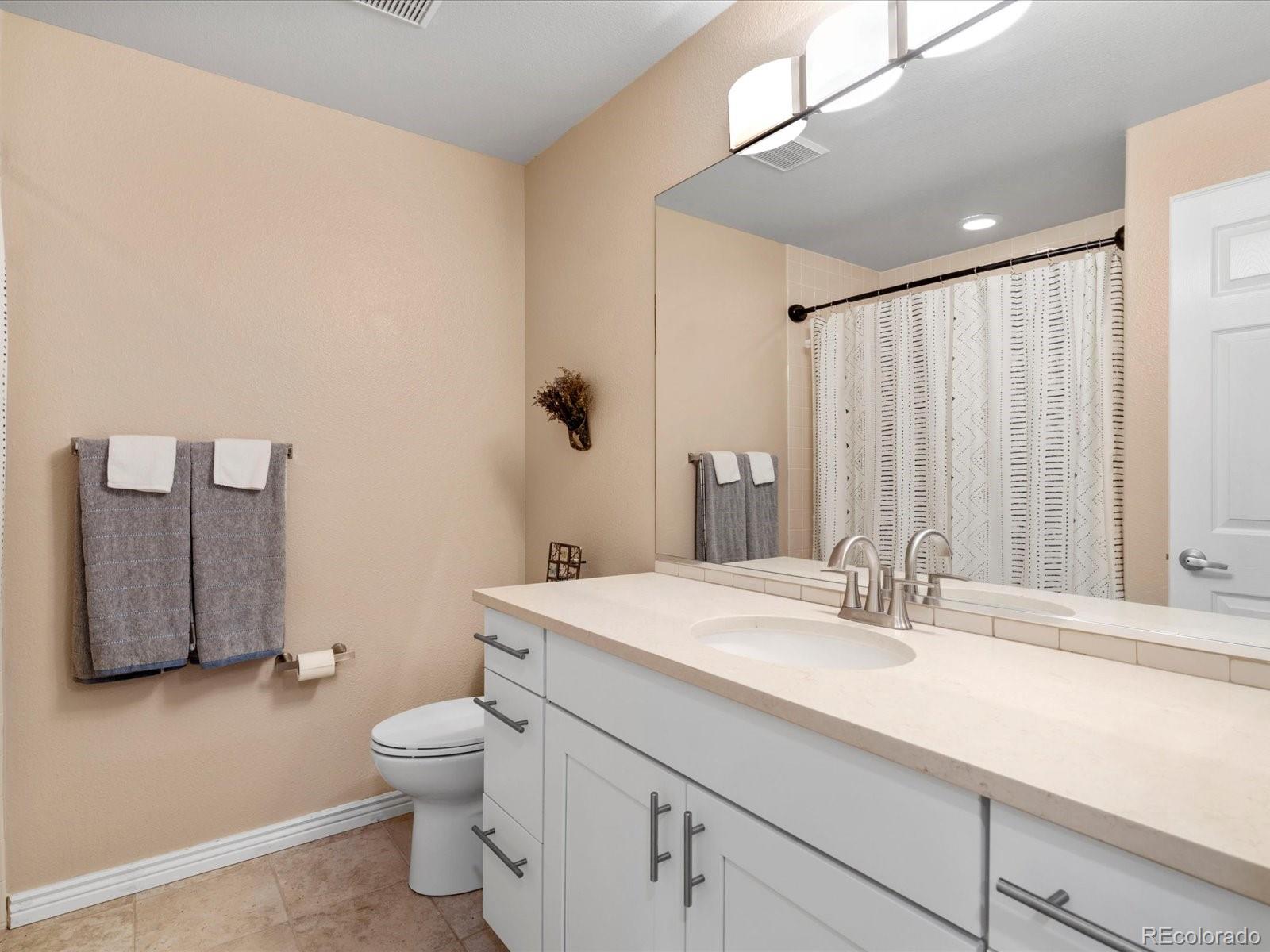 9323 Notts Court Lone Tree, CO 80124 - Photo 38 of 45 a bathroom with a sink toilet and shower