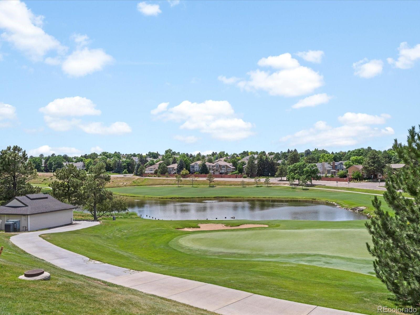 9323 Notts Court Lone Tree, CO 80124 - Photo 40 of 45 a view of a lake with a big yard