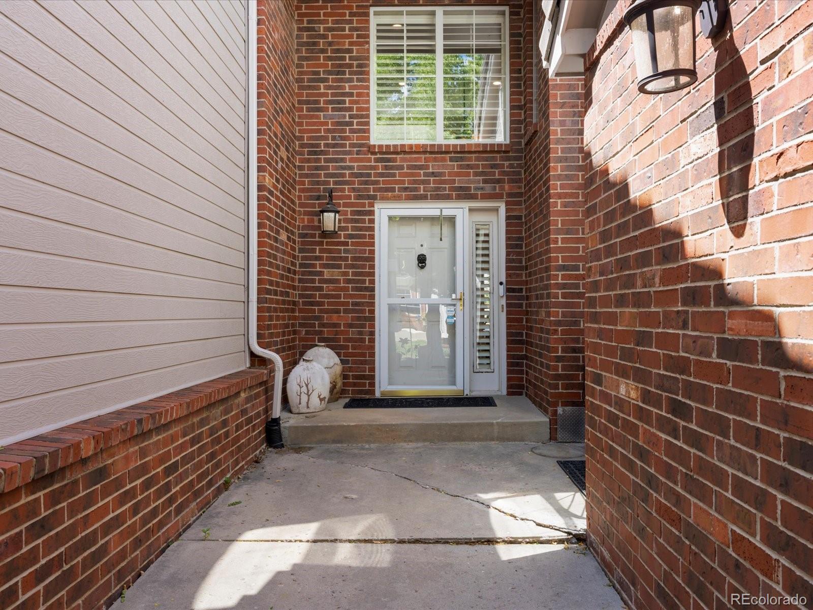 9323 Notts Court Lone Tree, CO 80124 - Photo 4 of 45 a view of a door with a bench