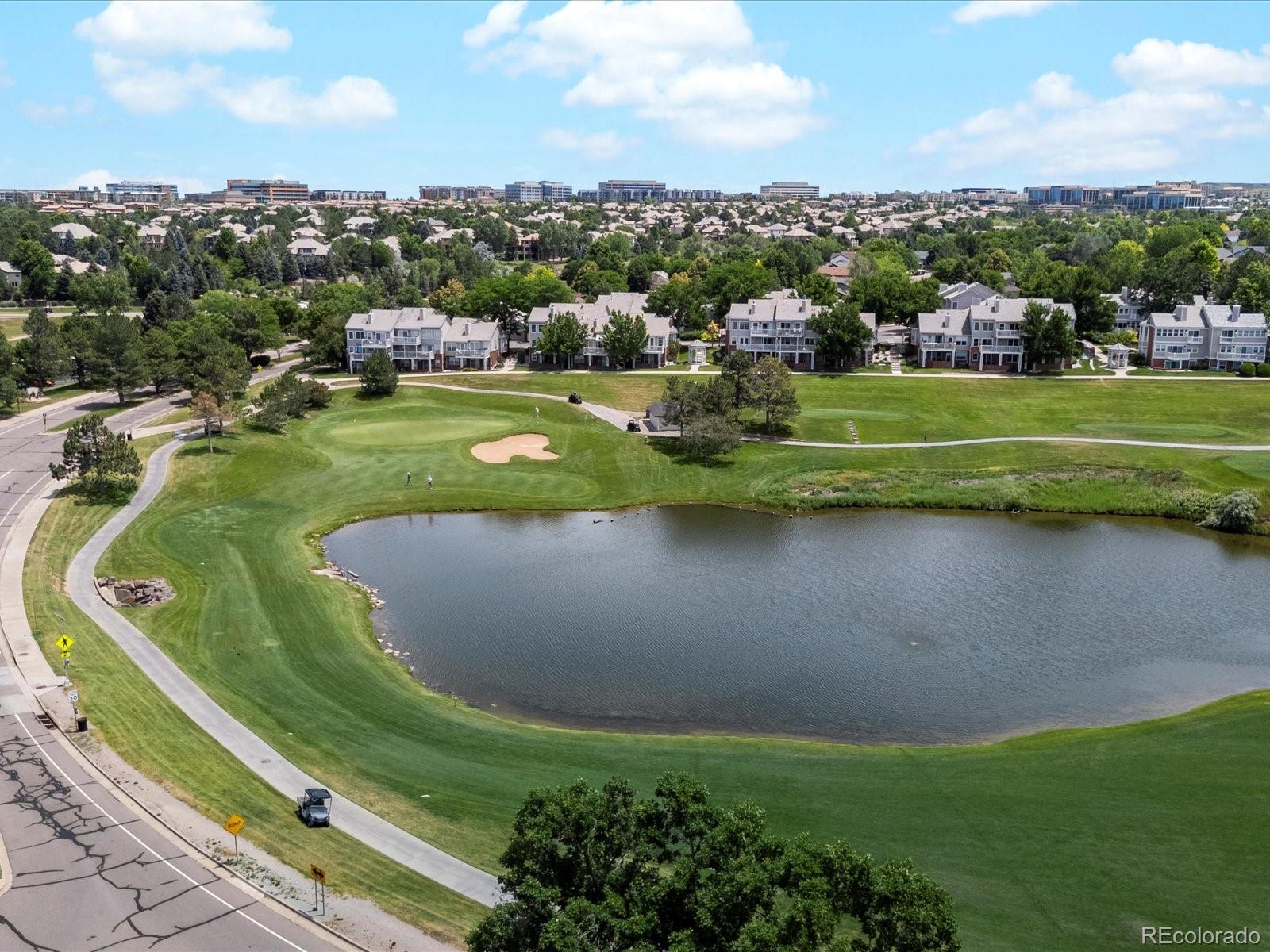9323 Notts Court Lone Tree, CO 80124 - Photo 44 of 45 a view of a golf course with a lake