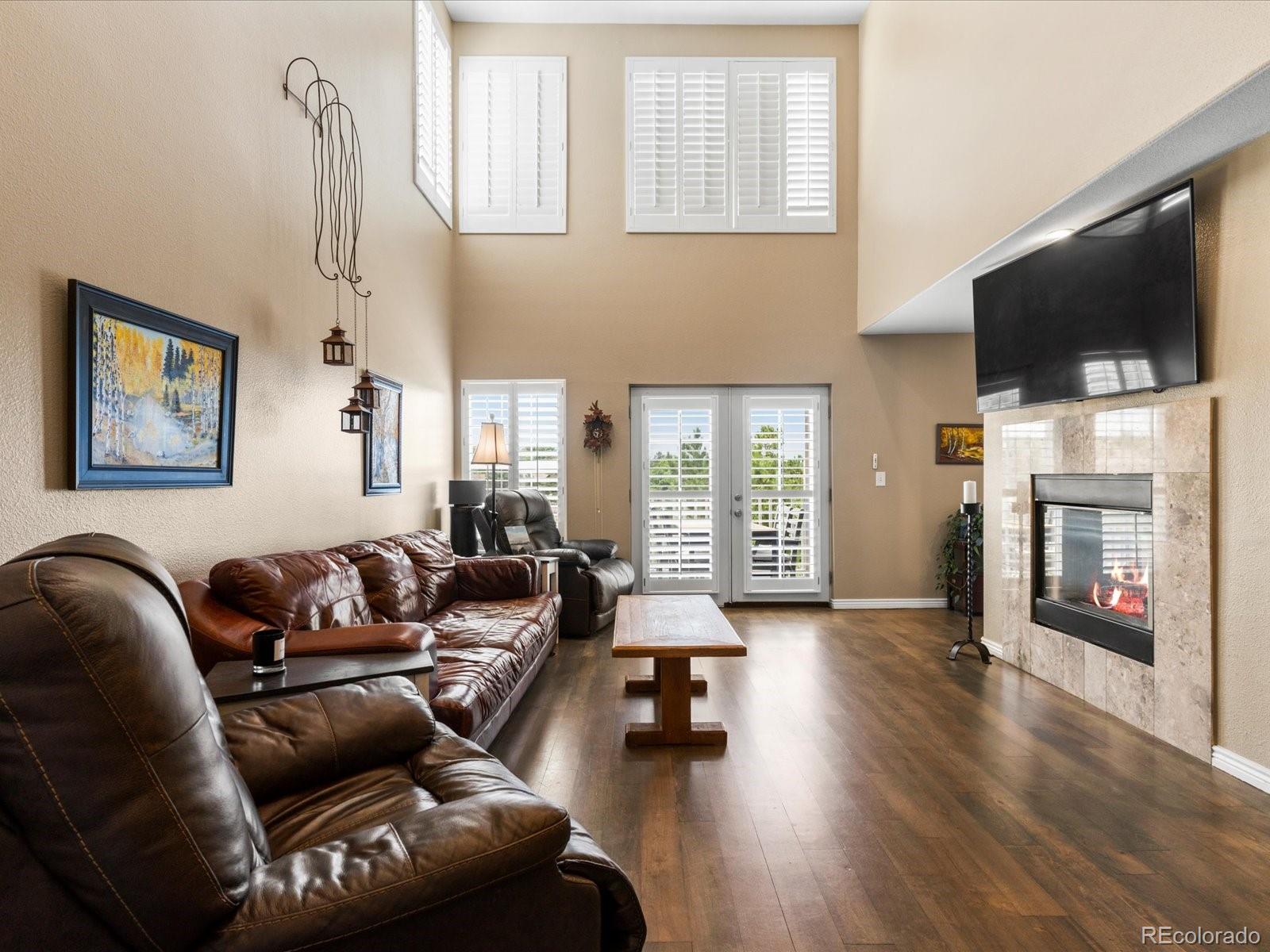 9323 Notts Court Lone Tree, CO 80124 - Photo 5 of 45 a living room with furniture fireplace and flat screen tv