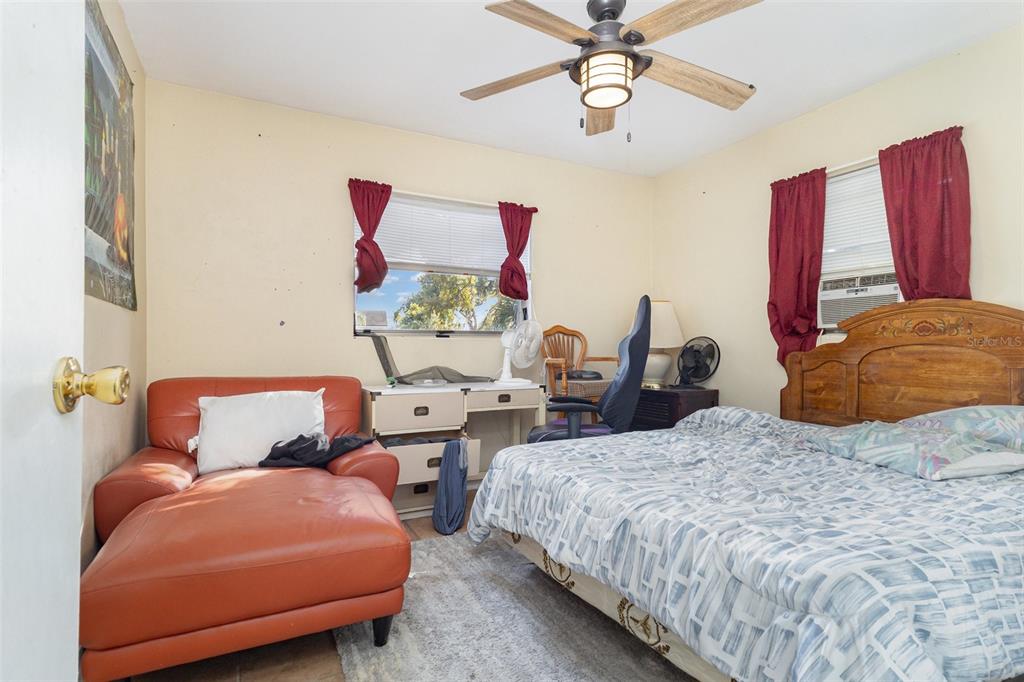 1638 East Main Street Lakeland, FL 33801 - Photo 11 of 16 a bedroom with two beds and a chandelier