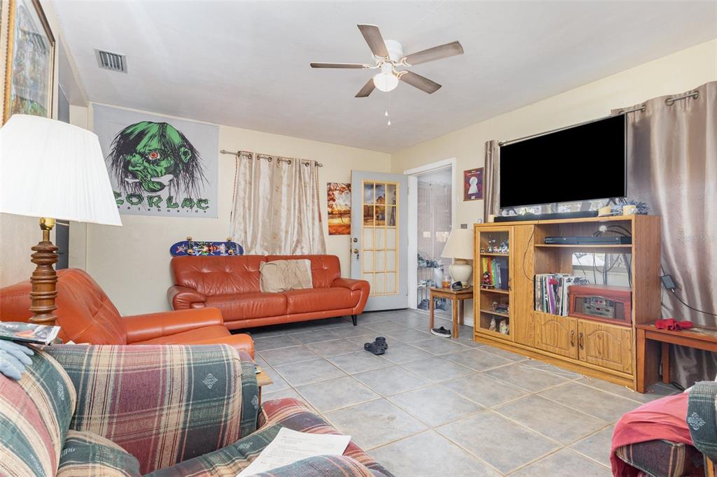 1638 East Main Street Lakeland, FL 33801 - Photo 5 of 16 a living room with furniture and a flat screen tv