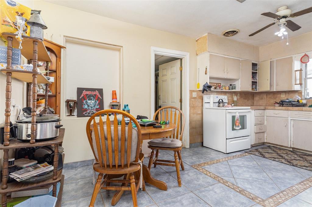 1638 East Main Street Lakeland, FL 33801 - Photo 6 of 16 a living room with furniture a dining table and kitchen view