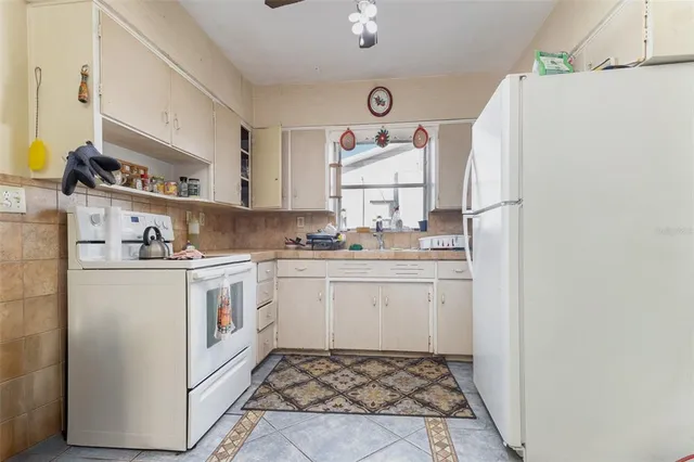 a bedroom with two beds and a chandelier