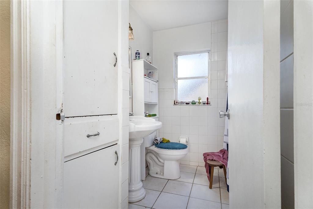 1638 East Main Street Lakeland, FL 33801 - Photo 9 of 16 a bathroom with a toilet and a shower