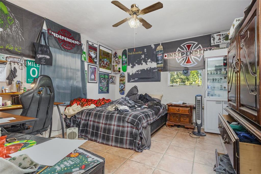 1638 East Main Street Lakeland, FL 33801 - Photo 10 of 16 a bedroom with furniture and a flat screen tv