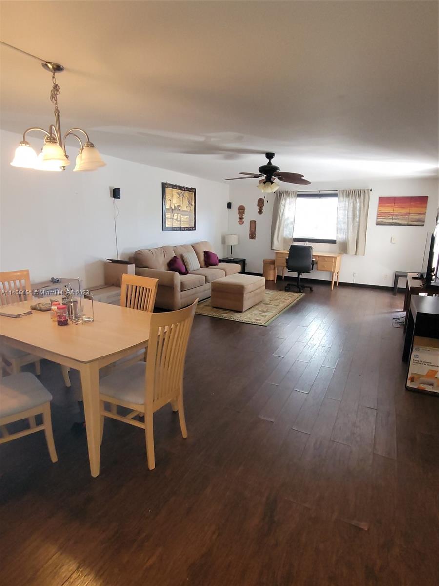 22605 Southwest 66th Avenue, Unit 207 Boca Raton, FL 33428 - Photo 15 of 15 a dining room with furniture and a chandelier