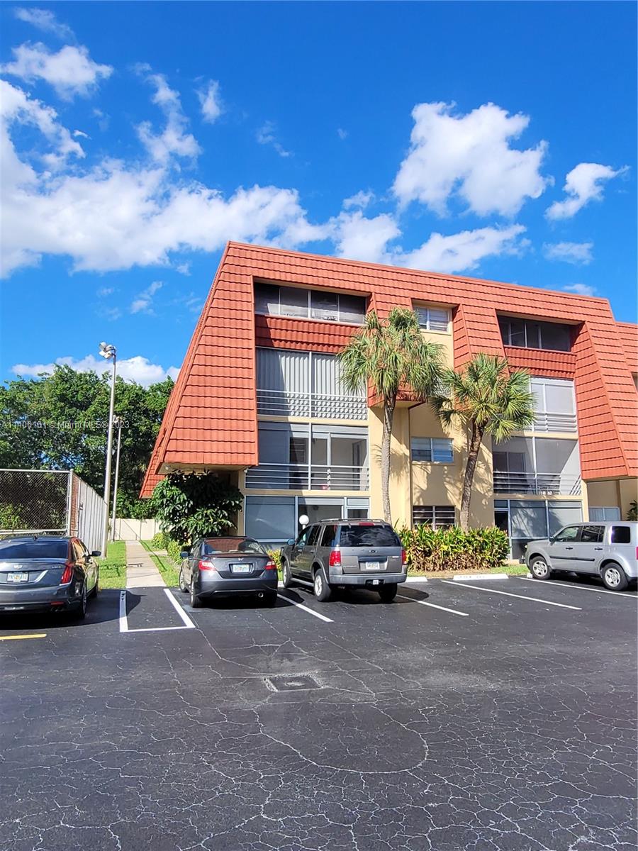 22605 Southwest 66th Avenue, Unit 207 Boca Raton, FL 33428 - Photo 2 of 15 a car parked in front of a house