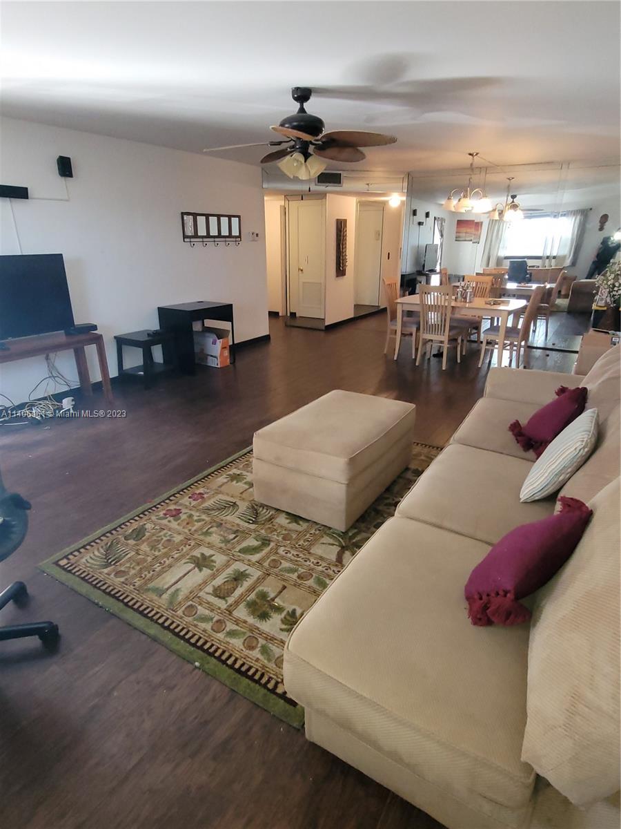 22605 Southwest 66th Avenue, Unit 207 Boca Raton, FL 33428 - Photo 5 of 15 a living room with furniture and kitchen view