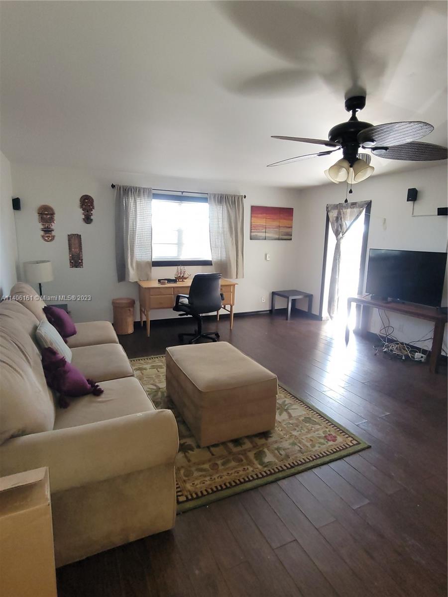 22605 Southwest 66th Avenue, Unit 207 Boca Raton, FL 33428 - Photo 6 of 15 a living room with furniture window and wooden floor