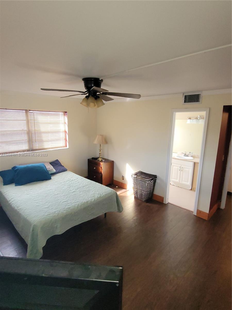22605 Southwest 66th Avenue, Unit 207 Boca Raton, FL 33428 - Photo 8 of 15 a view of a room with wooden floor and windows
