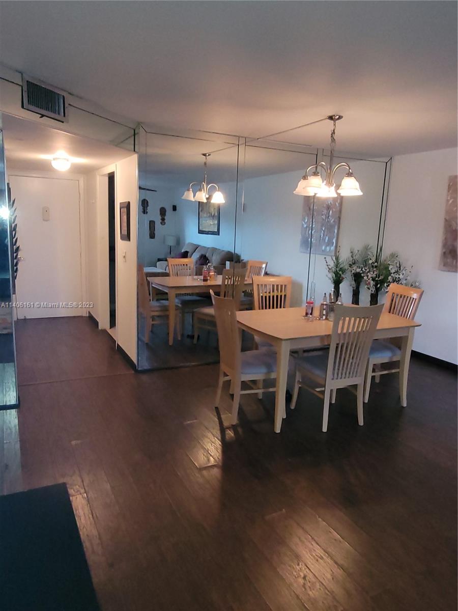22605 Southwest 66th Avenue, Unit 207 Boca Raton, FL 33428 - Photo 9 of 15 a view of a dining room with furniture and wooden floor
