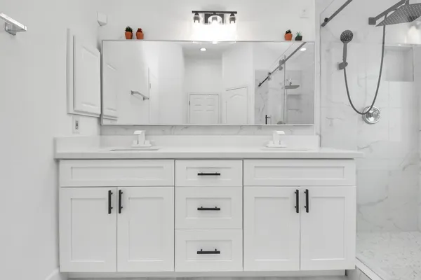 a bathroom with a sink vanity and a mirror