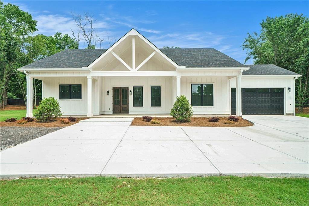 a front view of a house with yard and green space