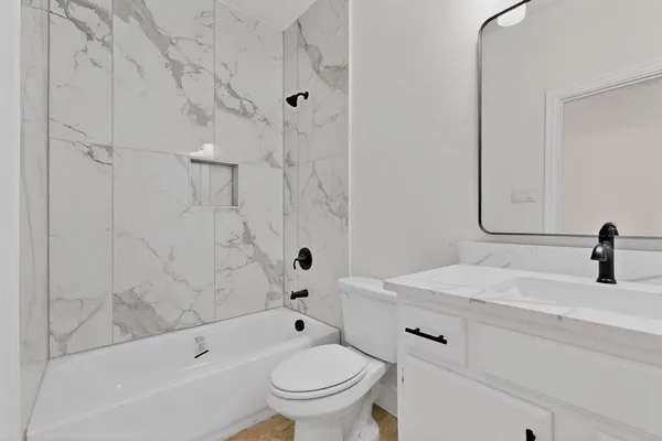 a bathroom with a sink a toilet and a bathtub