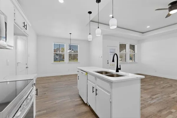 a kitchen with stainless steel appliances granite countertop a sink and dishwasher