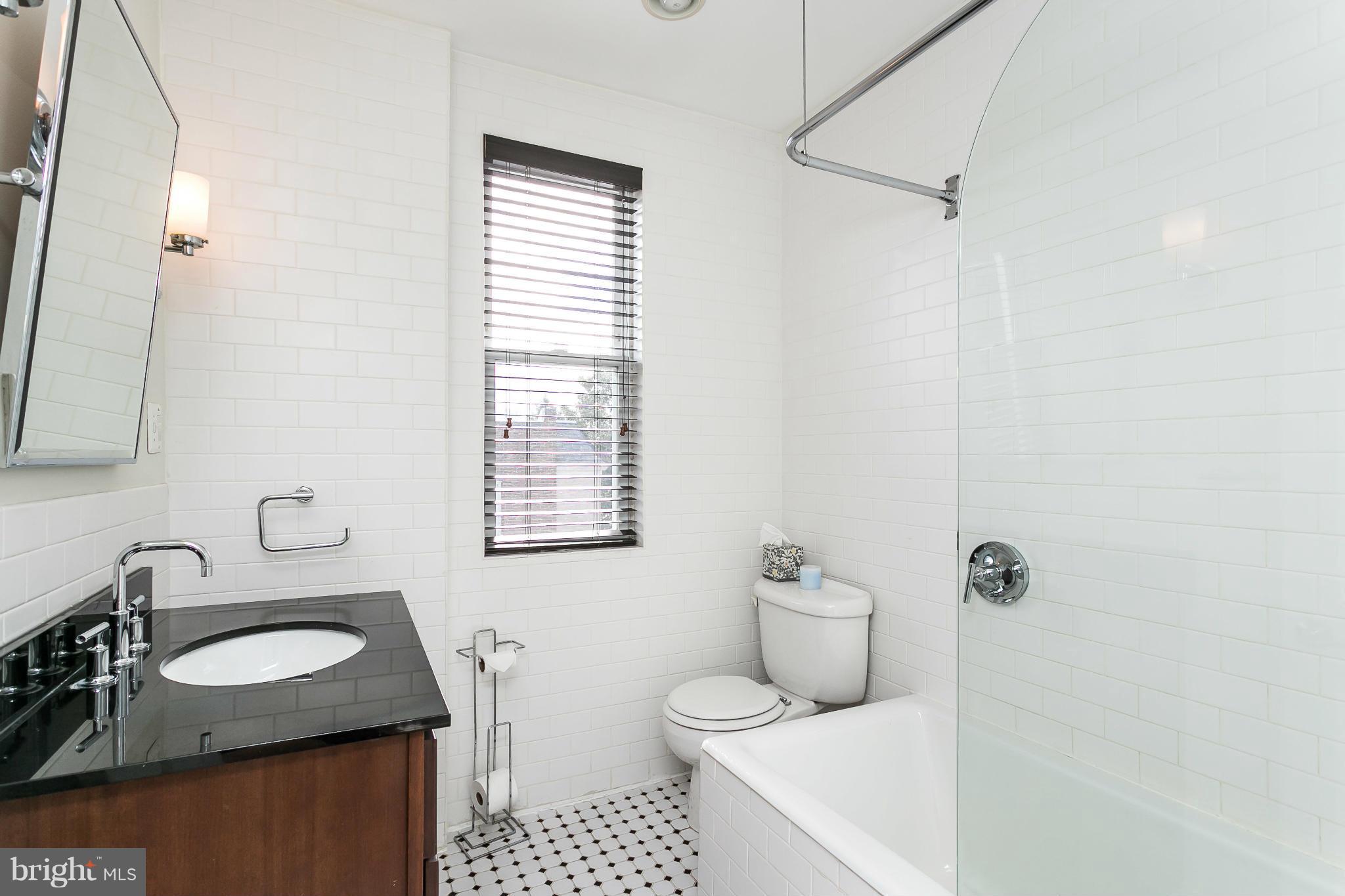 3733 Keswick Road Baltimore, MD 21211 - Photo 22 of 30 a bathroom with a granite countertop sink toilet and shower