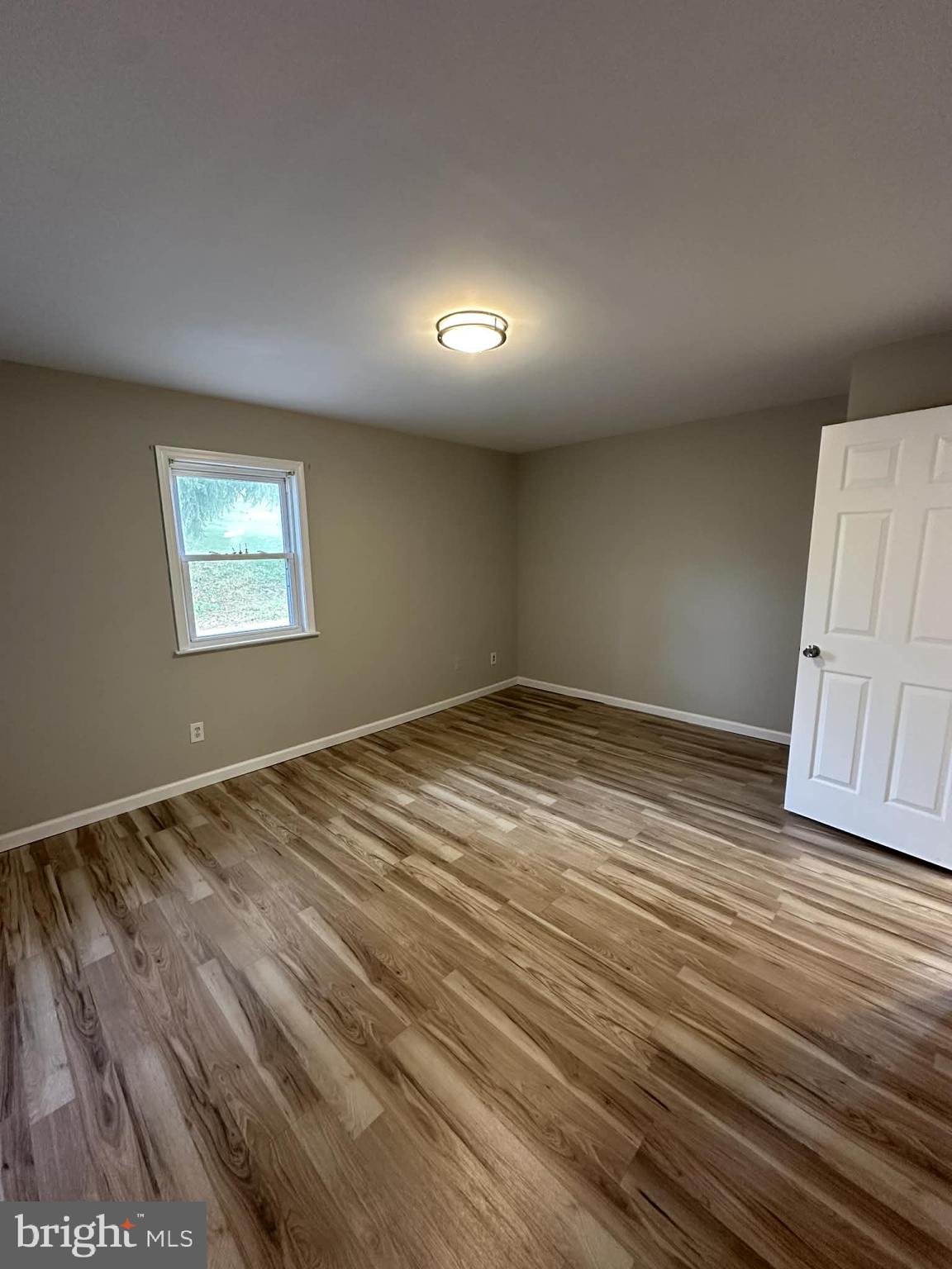 2642 Spring Road Chambersburg, PA 17202 - Photo 12 of 18 an empty room with wooden floor and windows