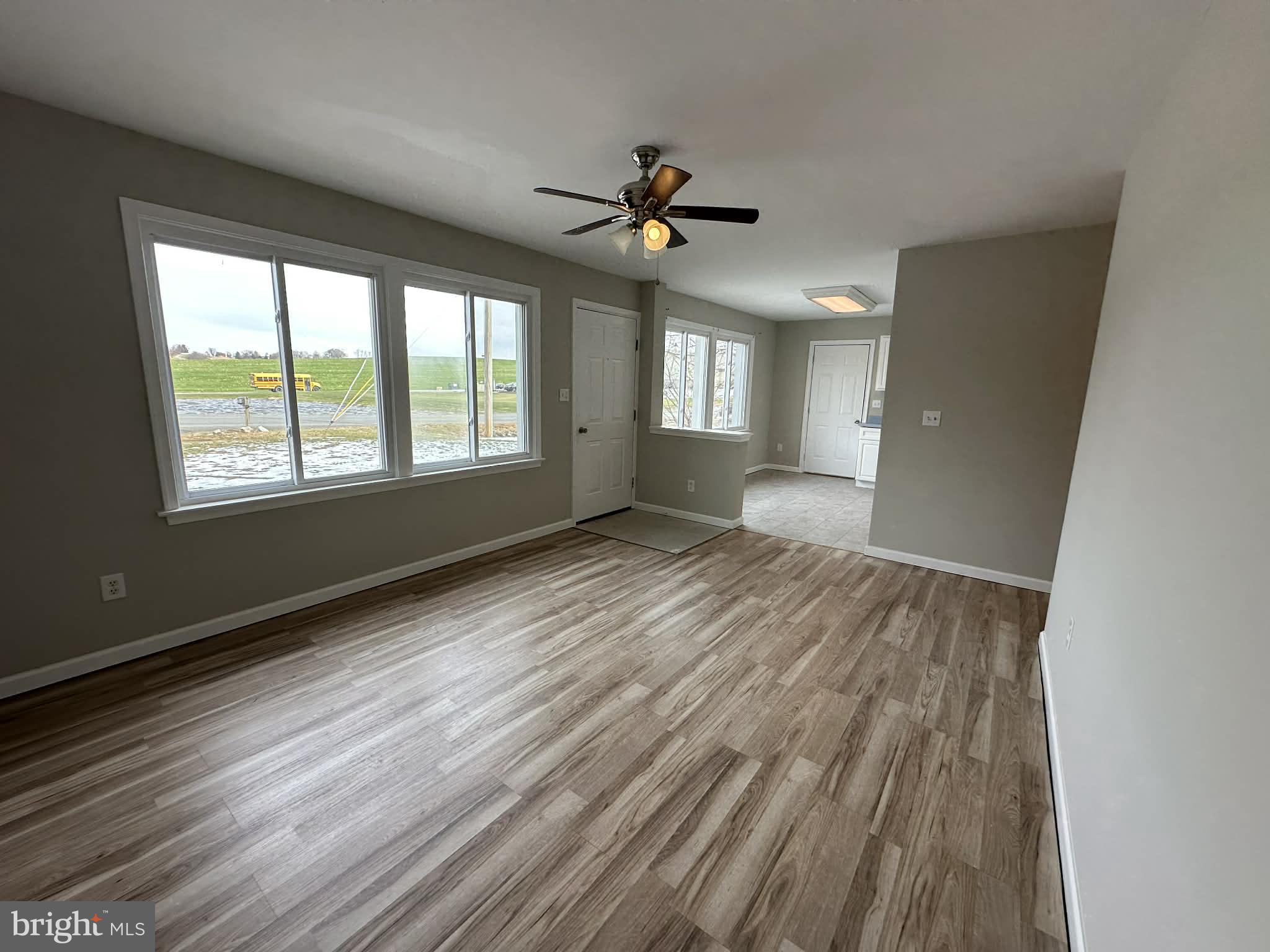2642 Spring Road Chambersburg, PA 17202 - Photo 5 of 18 a view of an empty room with a window and wooden floor