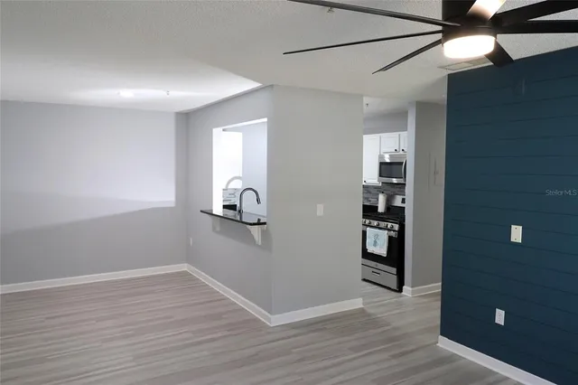 a view of a room with wooden floor and cabinet
