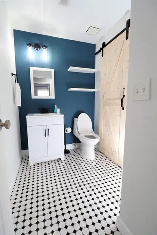 a bathroom with a toilet a sink and mirror