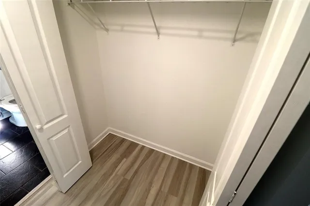a bathroom with a granite countertop shower and a toilet