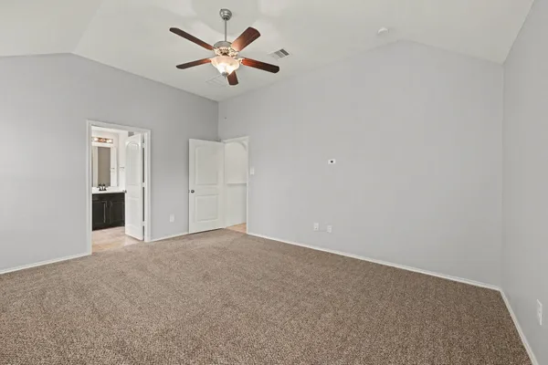an empty room with closet and windows
