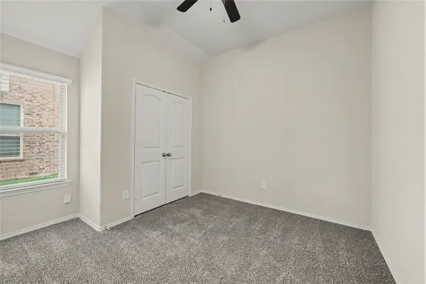 an empty room with windows and closet