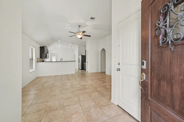 a view of a kitchen with a sink and a refrigerator