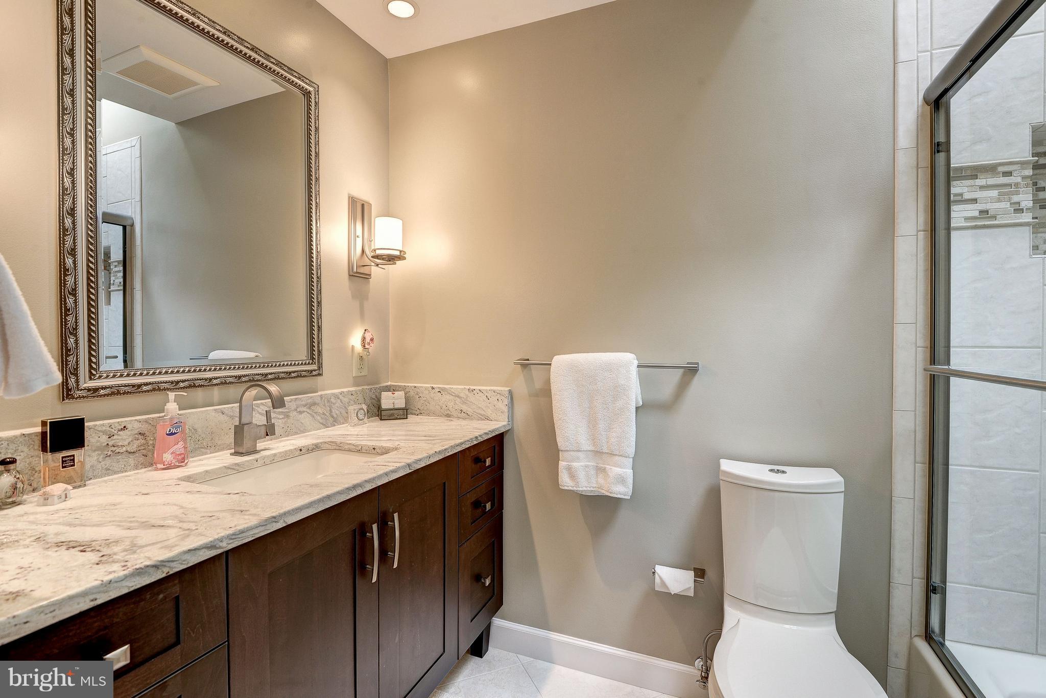 1636 Waters Edge Lane Reston, VA 20190 - Photo 22 of 30 a bathroom with a sink a toilet and mirror