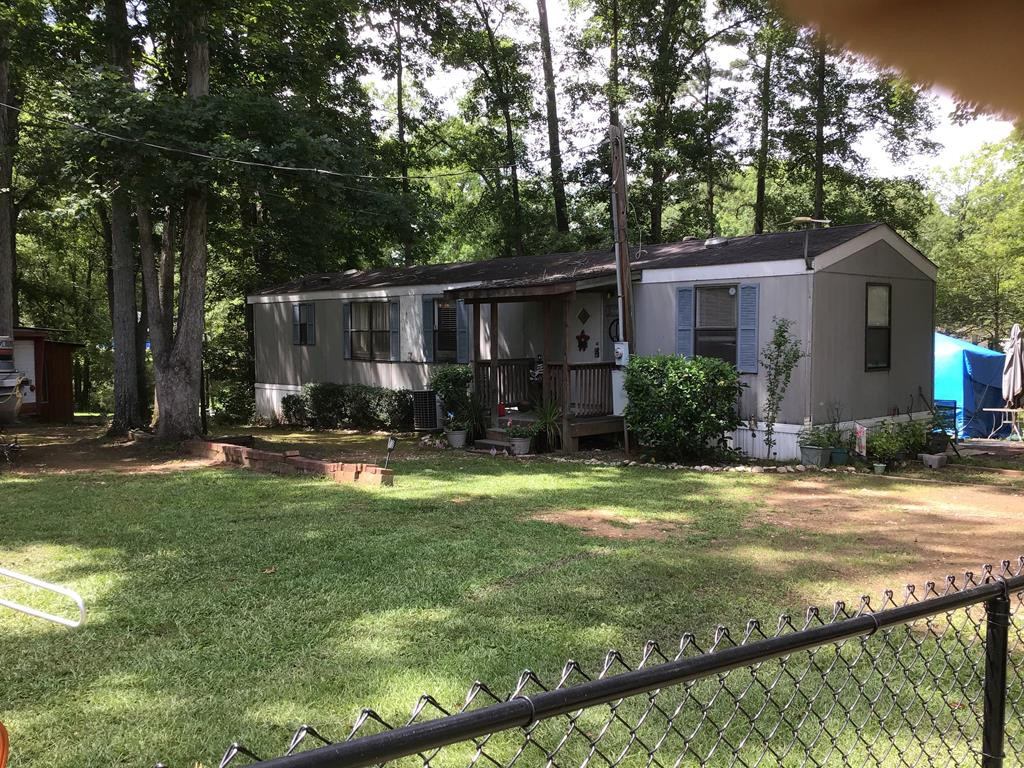 a view of a backyard with sitting area and furniture