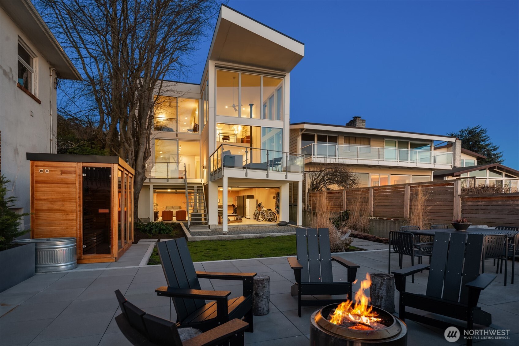 4717 Beach Drive Southwest Seattle, WA 98116 - Photo 4 of 11 a front view of a house with a yard patio and fire pit