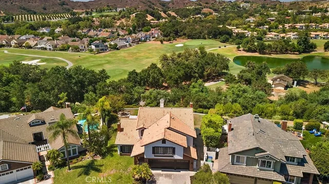 an aerial view of residential houses with outdoor space and river