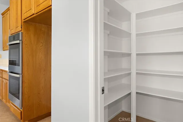 a kitchen with stainless steel appliances granite countertop wooden cabinets and a refrigerator