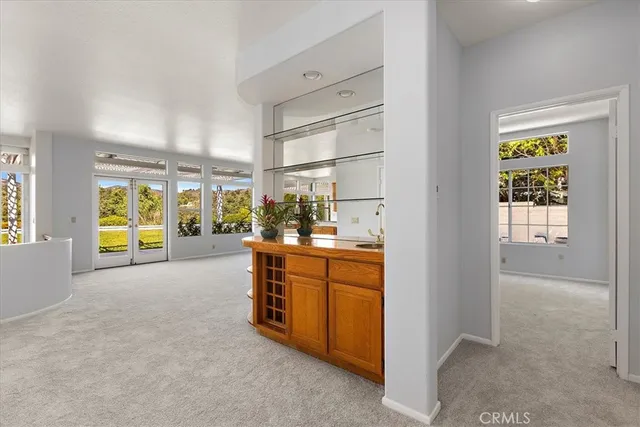 a living room with furniture a flat screen tv and a large window