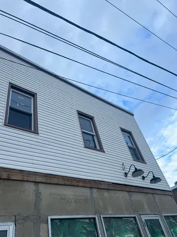 a view of a windows and small dishwasher