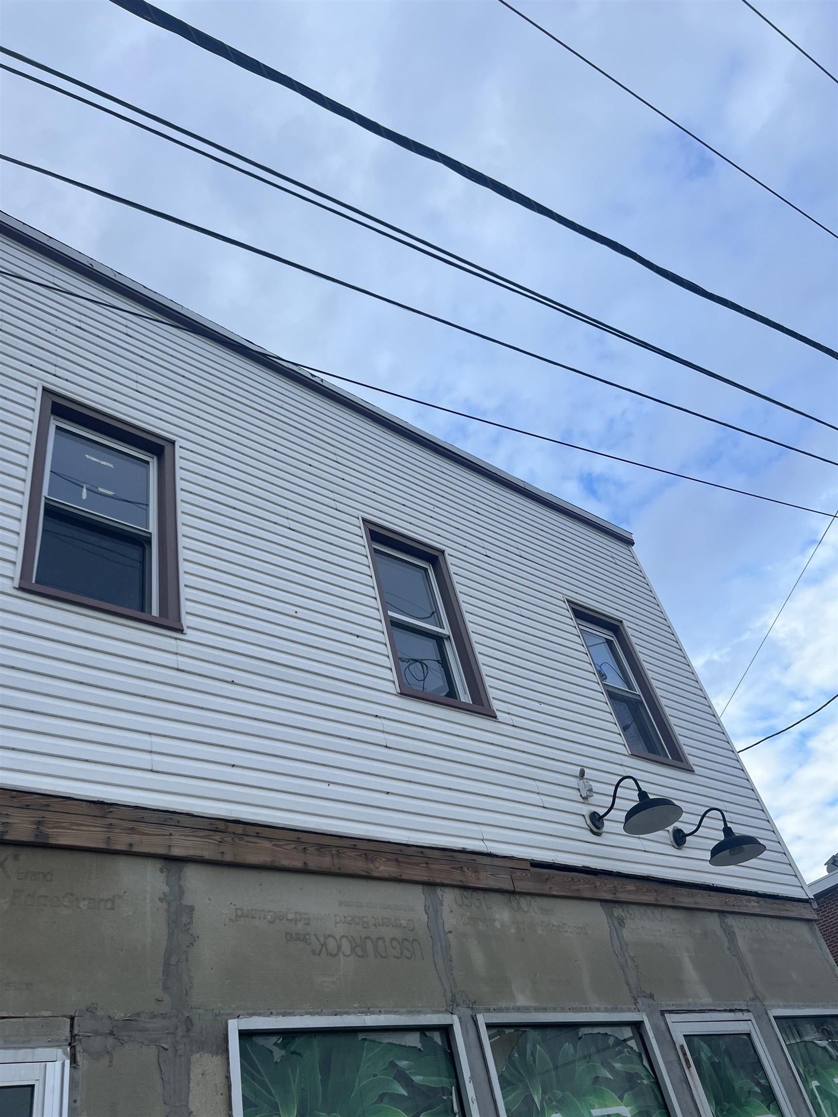 a view of a windows and small dishwasher