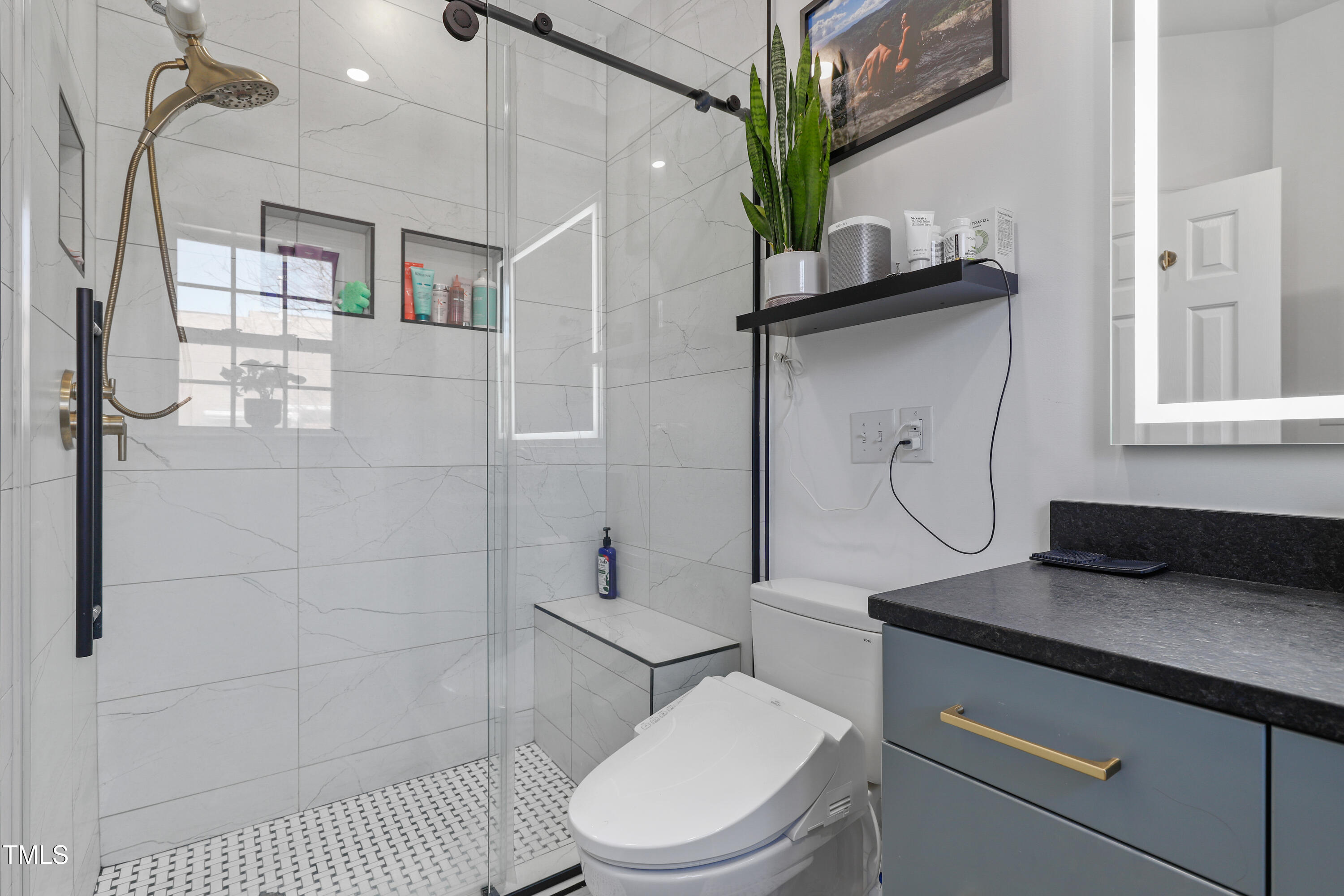 672 Highpark Lane Raleigh, NC 27608 - Photo 17 of 25 a bathroom with a toilet a sink and shower