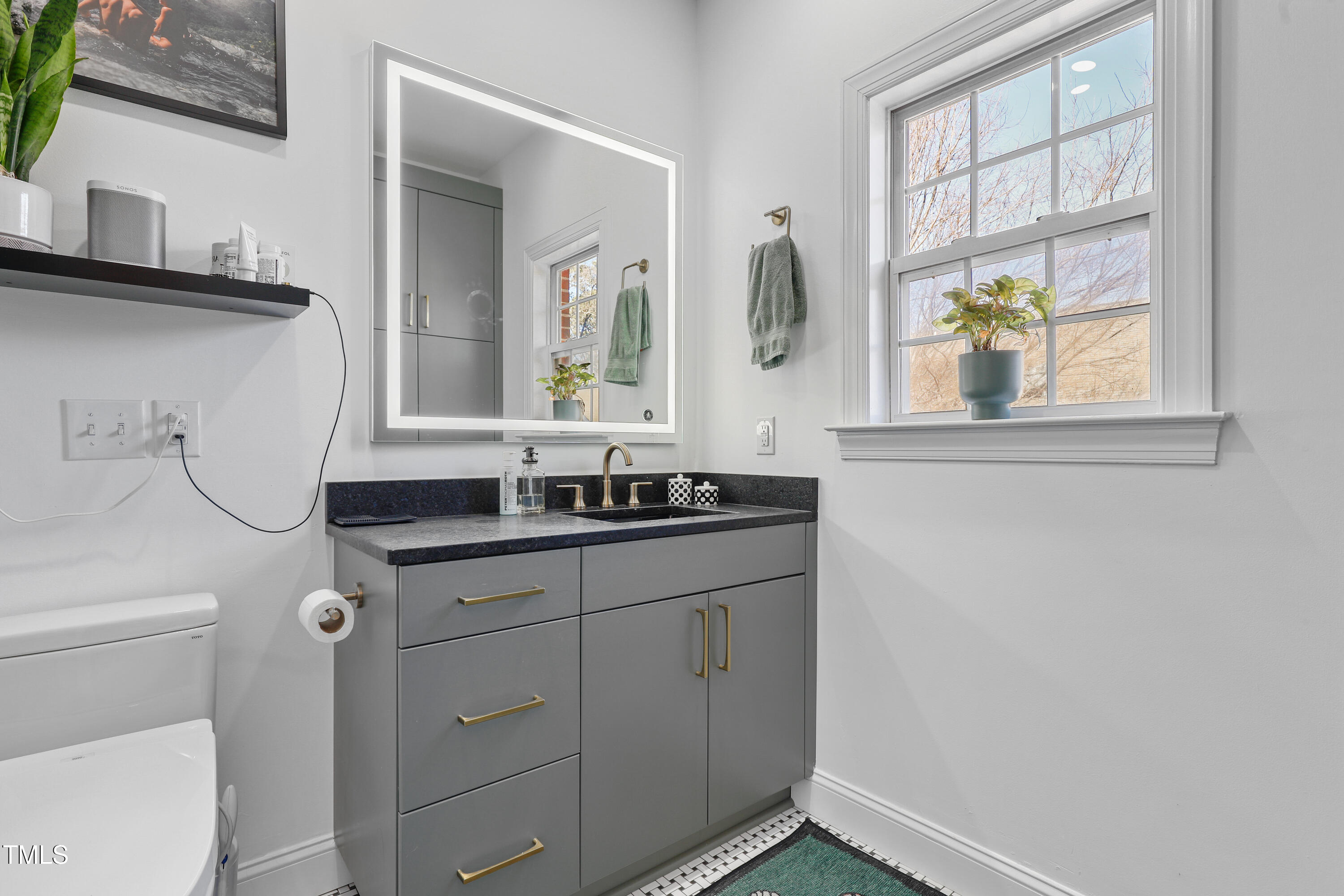 672 Highpark Lane Raleigh, NC 27608 - Photo 18 of 25 a bathroom with a sink and a window
