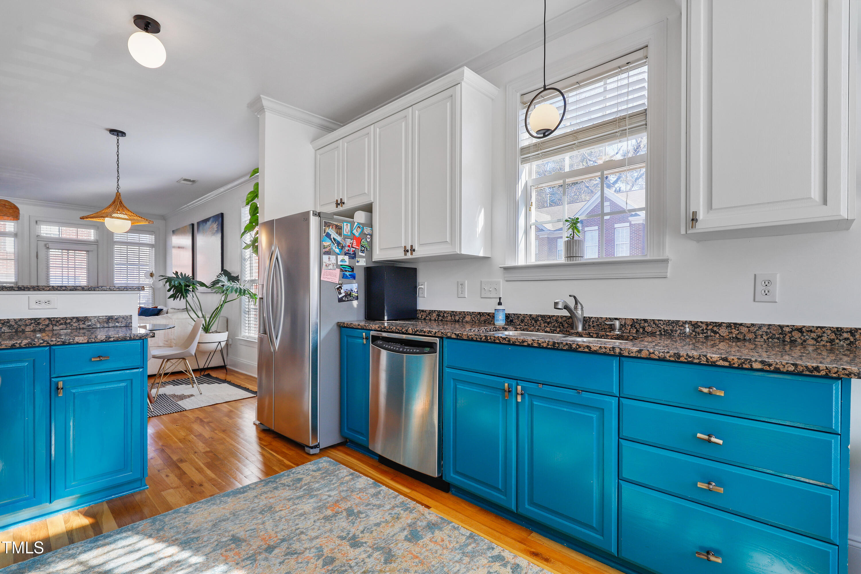 672 Highpark Lane Raleigh, NC 27608 - Photo 5 of 25 a kitchen with stainless steel appliances granite countertop a refrigerator a sink dishwasher a stove and white cabinets with wooden floor