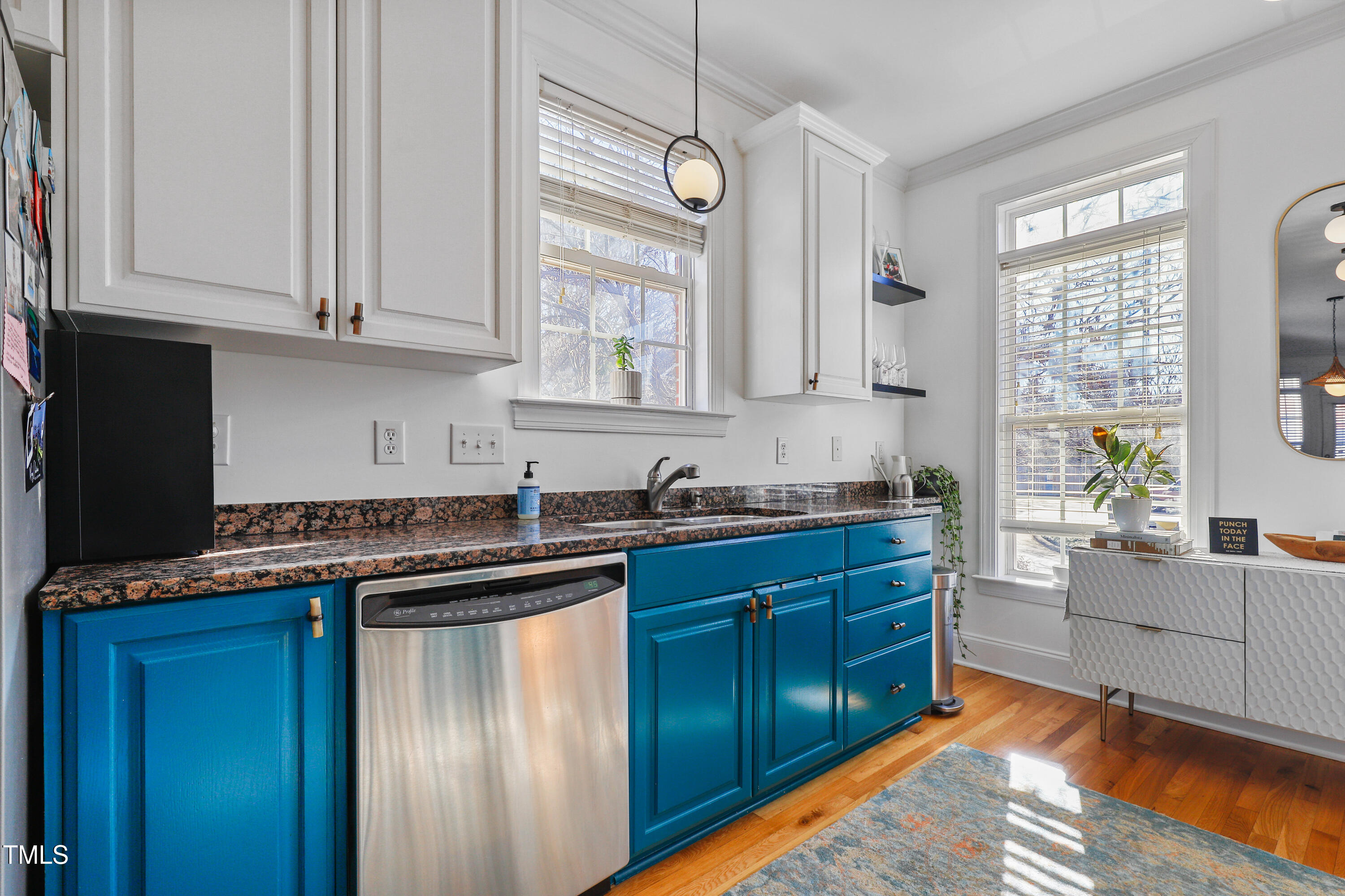 672 Highpark Lane Raleigh, NC 27608 - Photo 6 of 25 a kitchen with stainless steel appliances granite countertop a sink and cabinets with wooden floor