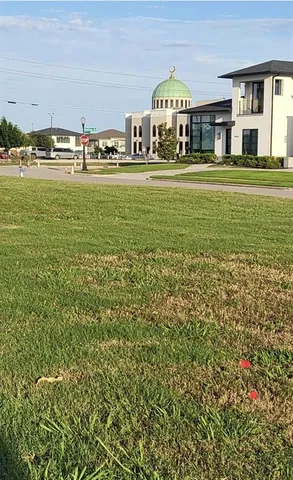 a view of a house with a yard and sitting area