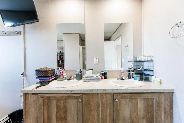 a view of walk in closet with clothes
