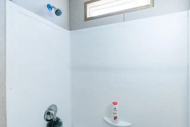 a bedroom with bed and a window