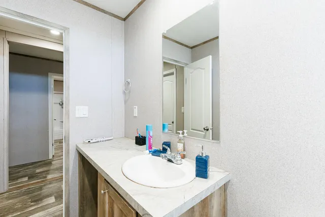 a living room with furniture a flat screen tv and a window